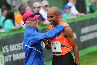 TD Beach to Beacon founder Joan Benoit Samuelson greets Meb Keflezighi at the finish of 2013 TD Beach to Beacon.