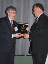 EMSEAL President and CEO Lester Hensley accepts the 2010 New England Innovations Award from SBANE President Bob Baker.
