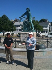 Gloucester Mayor Carolyn Kirk and DMSE President Dave McGillivray at the famous Gloucester Fisherman's Memorial Statue, the start/finish of the new Run Gloucester! 7-Mile Road Race on Aug. 22.